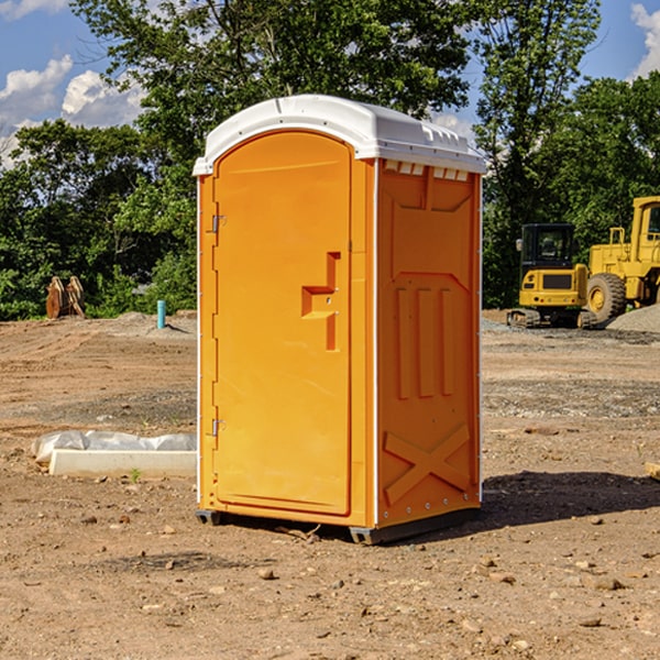 what is the cost difference between standard and deluxe portable restroom rentals in Delft Colony